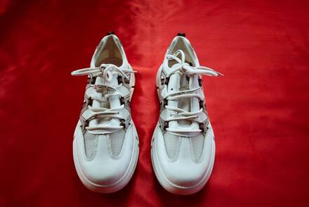 White sneakers on a red background
