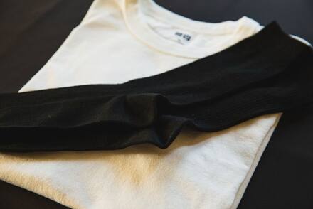 Folded black and cream t-shirts