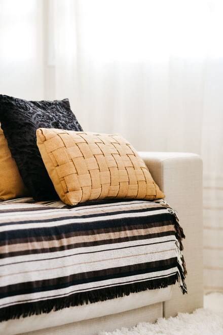 Cushions and a throw on a sofa