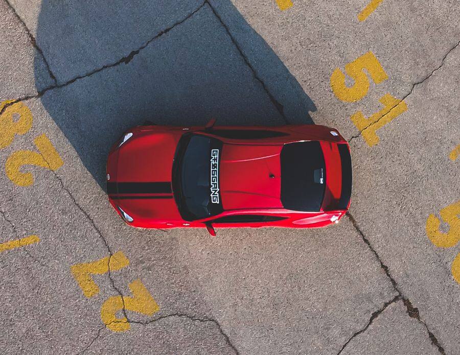 A red sedan seen from directly above