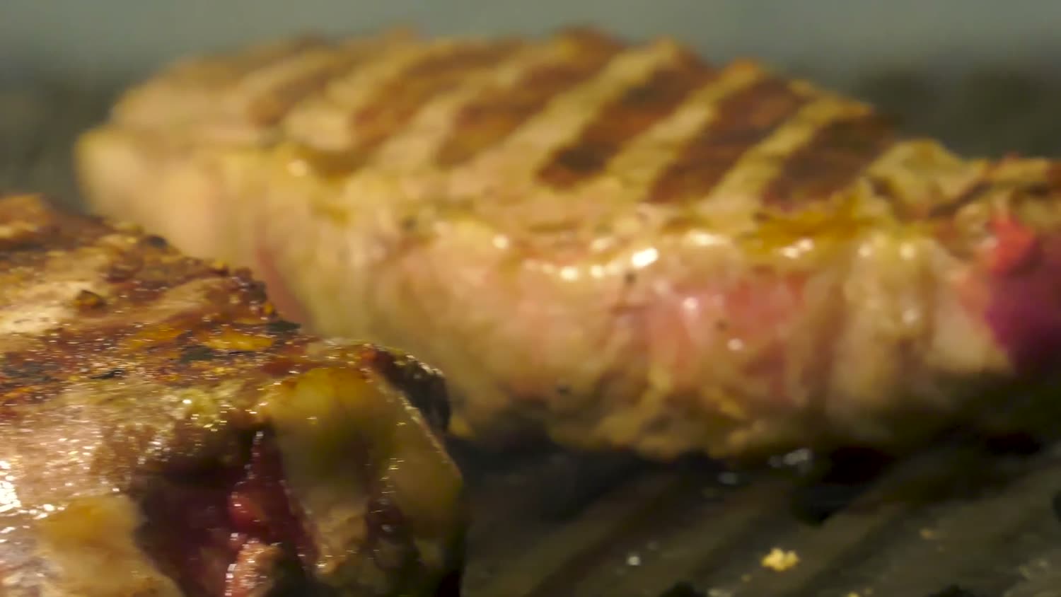 Char marks on a cut of meat off the grill