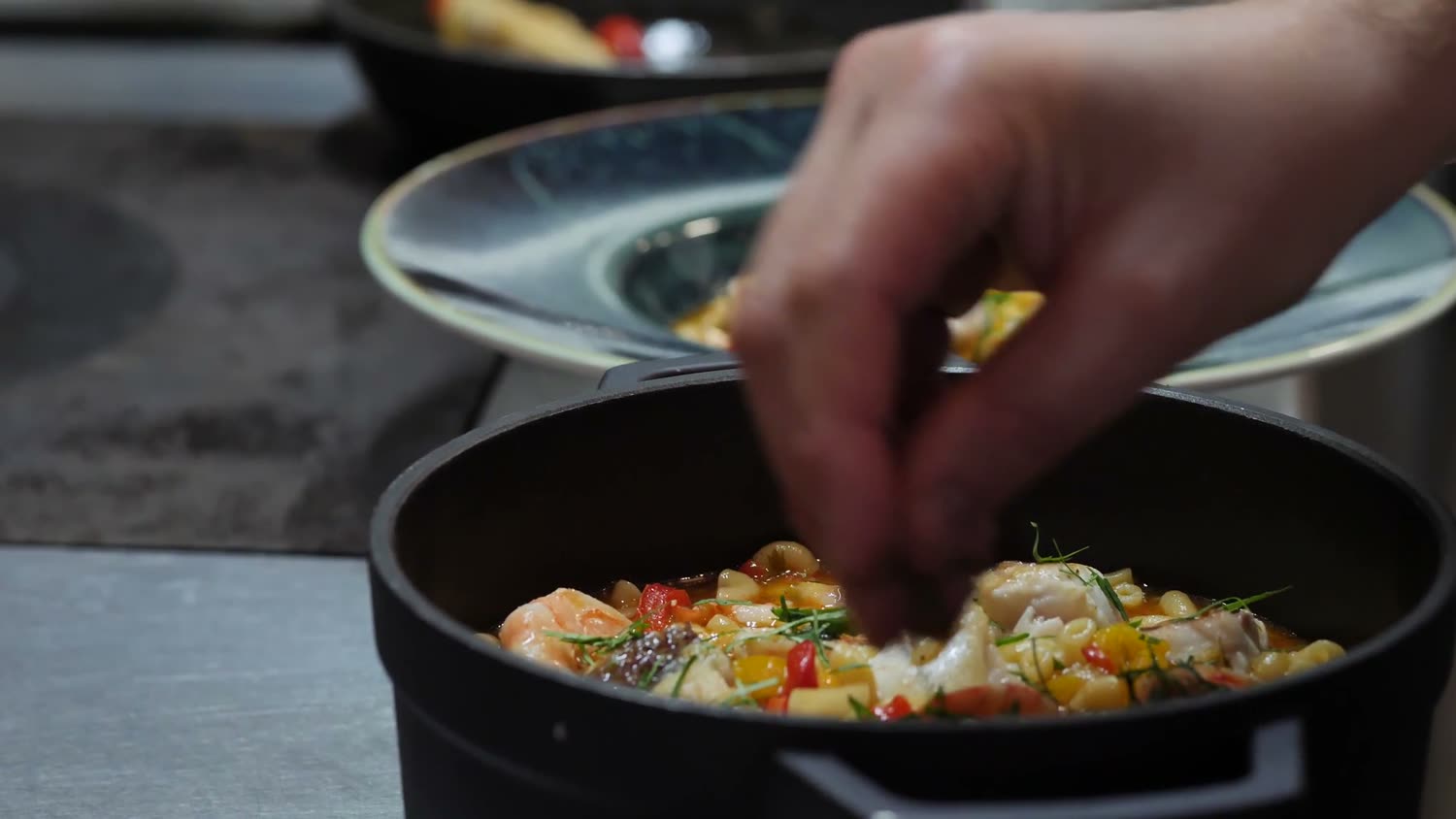 A dish being finished in the kitchen